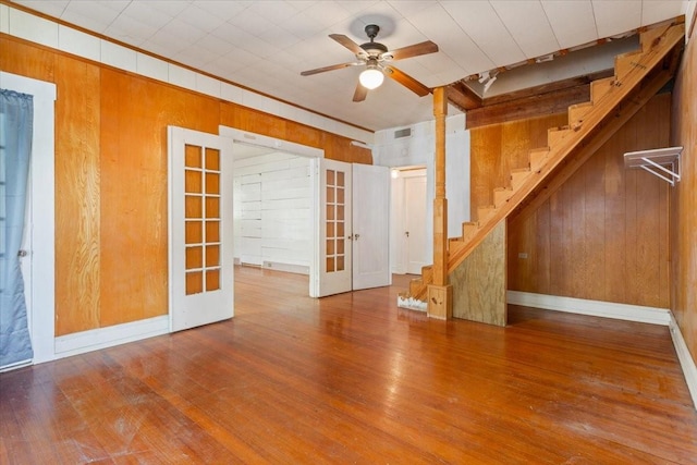 2600 Colcord Ave, Waco, TX 76707 - empty room with wood walls, french doors, stairway, wood finished floors, and ornamental molding
