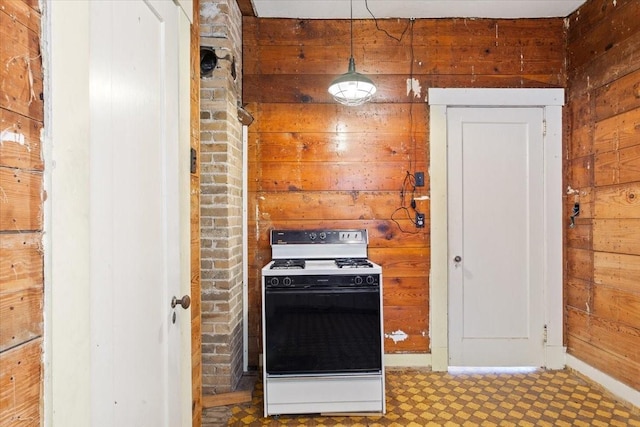 2600 Colcord Ave, Waco, TX 76707 - kitchen with electric range, wood walls, tile patterned floors, and baseboards