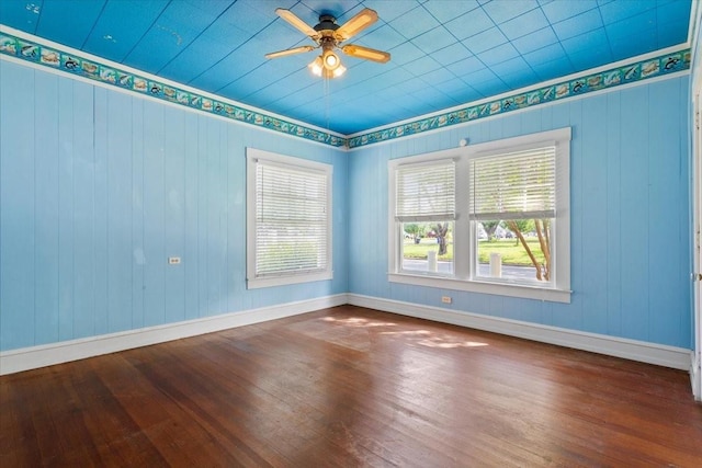 2600 Colcord Ave, Waco, TX 76707 - spare room with plenty of natural light, hardwood / wood-style flooring, ceiling fan, and wood walls