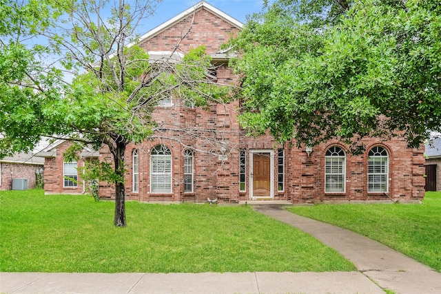 4005 Cavalier Dr, Rowlett, TX 75088 - view of front facade with cooling unit, a front lawn, and brick siding