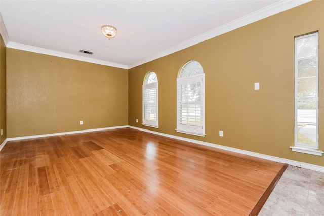 4005 Cavalier Dr, Rowlett, TX 75088 - spare room featuring crown molding, baseboards, and light wood-style floors