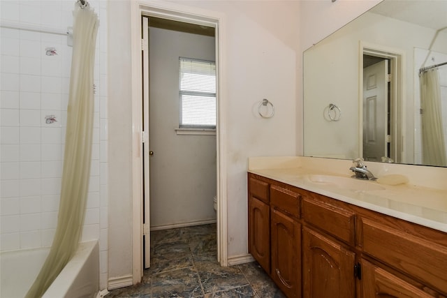 4005 Cavalier Dr, Rowlett, TX 75088 - bathroom with toilet, vanity, shower / tub combo, and stone finish floors