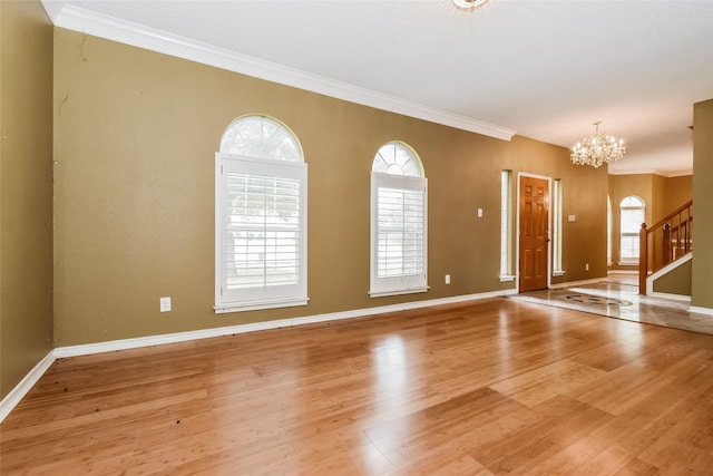 4005 Cavalier Dr, Rowlett, TX 75088 - foyer with a chandelier, light wood-style flooring, baseboards, and crown molding