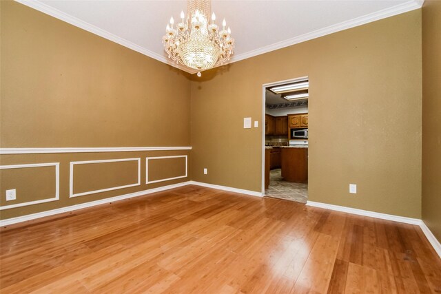 4005 Cavalier Dr, Rowlett, TX 75088 - unfurnished room featuring light wood-style flooring, a chandelier, crown molding, and baseboards