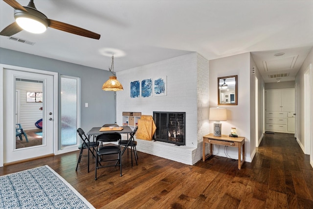 2816 Nottingham Dr, Denton, TX 76209 - dining room with attic access, a ceiling fan, hardwood / wood-style floors, a fireplace, and baseboards