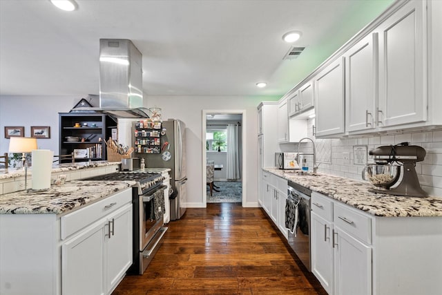 2816 Nottingham Dr, Denton, TX 76209 - kitchen featuring appliances with stainless steel finishes, decorative backsplash, dark wood-type flooring, white cabinetry, and recessed lighting