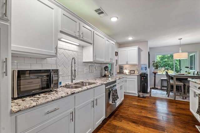 2816 Nottingham Dr, Denton, TX 76209 - kitchen featuring a sink, stainless steel dishwasher, black microwave, backsplash, and dark wood-type flooring