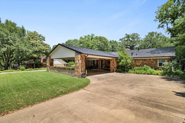 2816 Nottingham Dr, Denton, TX 76209 - view of front of home with stone siding, a front yard, driveway, a chimney, and a carport