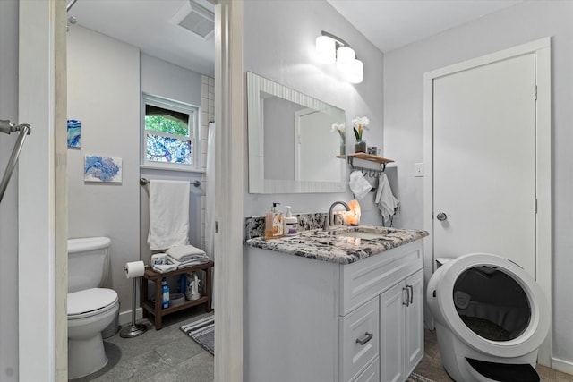 2816 Nottingham Dr, Denton, TX 76209 - bathroom featuring toilet, vanity, and baseboards