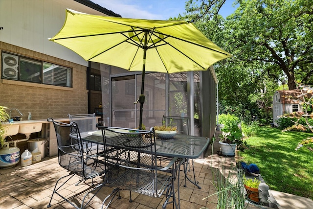 2816 Nottingham Dr, Denton, TX 76209 - view of patio featuring outdoor dining space and a storage shed