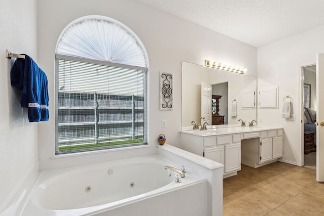 102 Pinion Dr, Euless, TX 76039 - full bath with double vanity, tile patterned flooring, a jetted tub, and ensuite bathroom