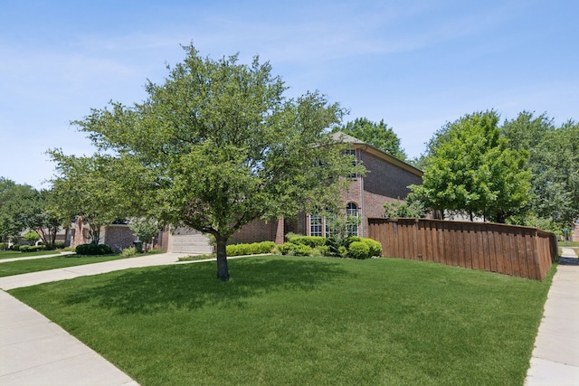 102 Pinion Dr, Euless, TX 76039 - obstructed view of property featuring brick siding, driveway, and a front yard