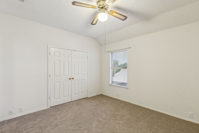 102 Pinion Dr, Euless, TX 76039 - unfurnished bedroom featuring carpet, a closet, lofted ceiling, a textured ceiling, and a ceiling fan