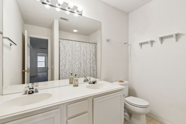 102 Pinion Dr, Euless, TX 76039 - bathroom featuring double vanity, toilet, and tile patterned flooring