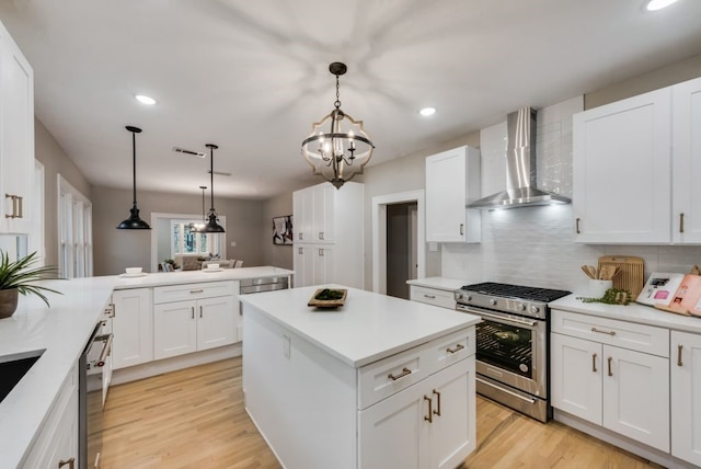 5836 Marquita Ave, Dallas, TX 75206 - kitchen featuring stainless steel gas stove, wall chimney exhaust hood, recessed lighting, backsplash, and a center island