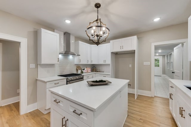 5836 Marquita Ave, Dallas, TX 75206 - kitchen featuring wall chimney range hood, stainless steel range with gas cooktop, a chandelier, light wood-type flooring, and recessed lighting