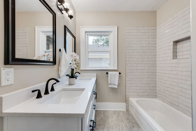 5836 Marquita Ave, Dallas, TX 75206 - bathroom featuring double vanity, baseboards, and marble look tiles
