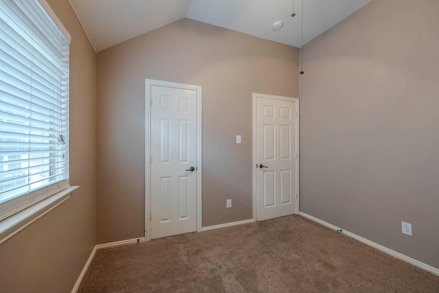12315 Red Hawk Dr, Frisco, TX 75033 - empty room with vaulted ceiling, carpet flooring, and baseboards