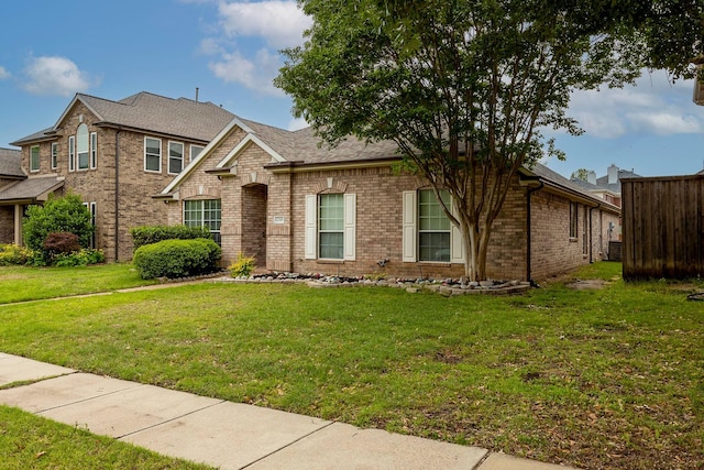 12315 Red Hawk Dr, Frisco, TX 75033 - view of front of home featuring brick siding, a front lawn, and roof with shingles