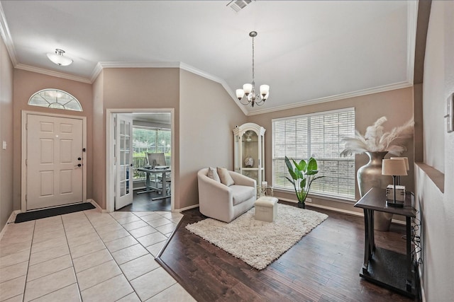12315 Red Hawk Dr, Frisco, TX 75033 - entryway with ornamental molding, a chandelier, baseboards, and wood finished floors
