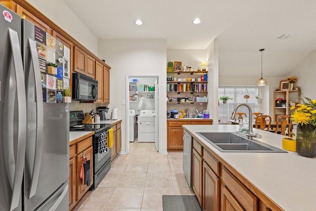 3705 Applewood Rd, Melissa, TX 75454 - kitchen with black appliances, a sink, washing machine and clothes dryer, light tile patterned floors, and light countertops