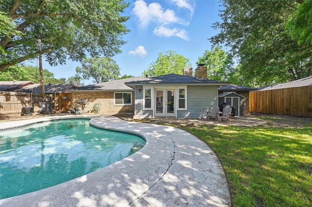 3407 Dovecreek Dr, Arlington, TX 76016 - rear view of house featuring french doors, a chimney, and a patio area