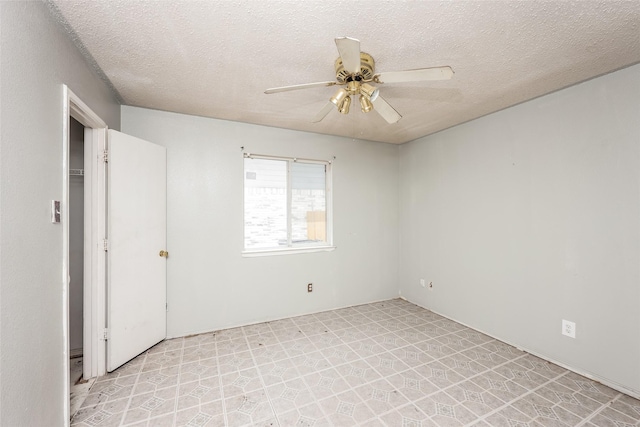 7922 Jubilant Dr, Dallas, TX 75237 - spare room with a ceiling fan, a textured ceiling, and light floors