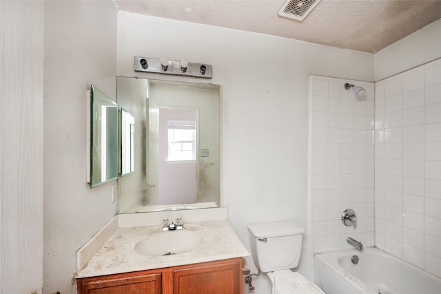 7922 Jubilant Dr, Dallas, TX 75237 - bathroom featuring vanity, toilet, shower / washtub combination, and a textured ceiling
