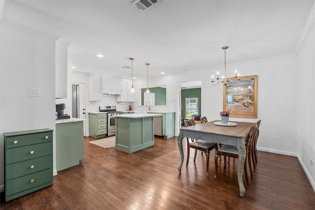 211 N 40th St, Waco, TX 76710 - kitchen with green cabinets, stainless steel range with gas stovetop, custom range hood, a kitchen island, and tasteful backsplash