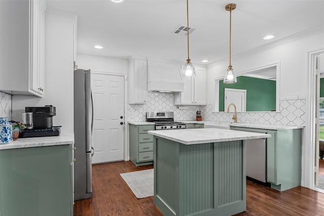 211 N 40th St, Waco, TX 76710 - kitchen featuring green cabinets, stainless steel appliances, premium range hood, white cabinetry, and tasteful backsplash