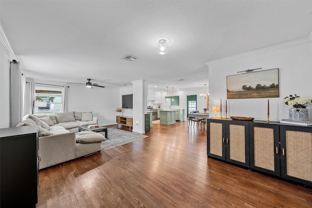211 N 40th St, Waco, TX 76710 - living room featuring wood finished floors, ceiling fan, ornamental molding, and a chandelier