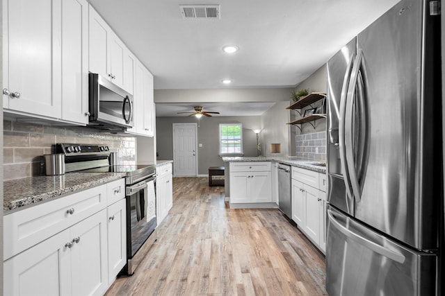 406 N Ruddell St, Denton, TX 76209 - kitchen with appliances with stainless steel finishes, light wood-style flooring, a ceiling fan, white cabinets, and recessed lighting