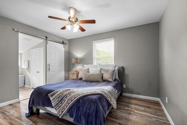 406 N Ruddell St, Denton, TX 76209 - bedroom with a barn door, wood finished floors, baseboards, and a ceiling fan