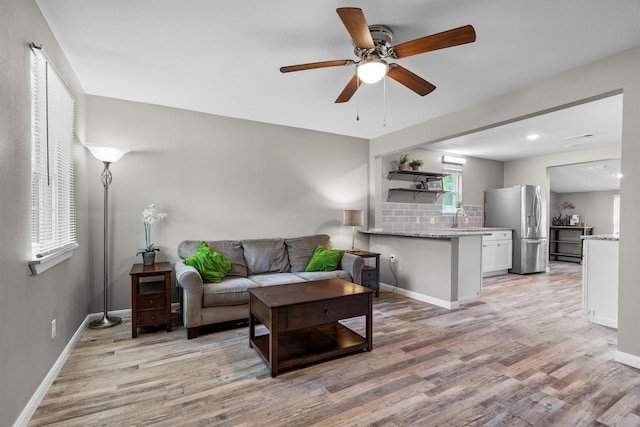 406 N Ruddell St, Denton, TX 76209 - living room with light wood finished floors, ceiling fan, and baseboards