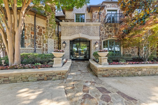 2 Terrabella Ln, Heath, TX 75032 - property entrance with french doors, stone siding, and brick siding