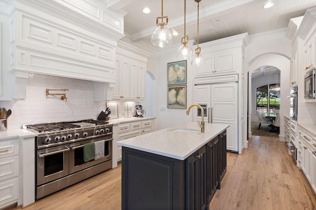 2 Terrabella Ln, Heath, TX 75032 - kitchen with built in appliances, arched walkways, a sink, white cabinetry, and ornamental molding