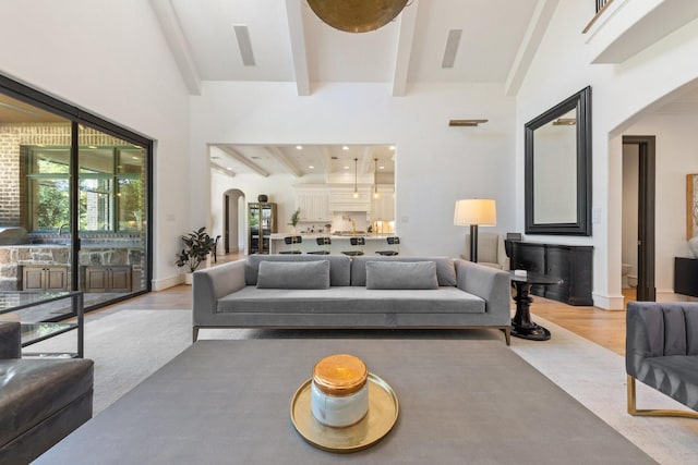 2 Terrabella Ln, Heath, TX 75032 - living room featuring arched walkways, light wood-type flooring, and beamed ceiling