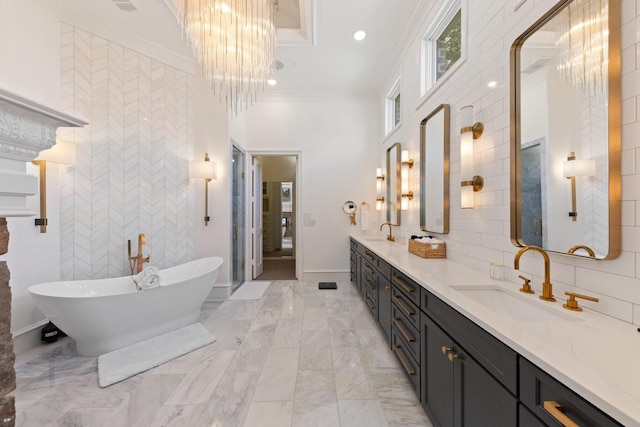 2 Terrabella Ln, Heath, TX 75032 - full bathroom featuring a soaking tub, double vanity, a chandelier, crown molding, and marble finish floors