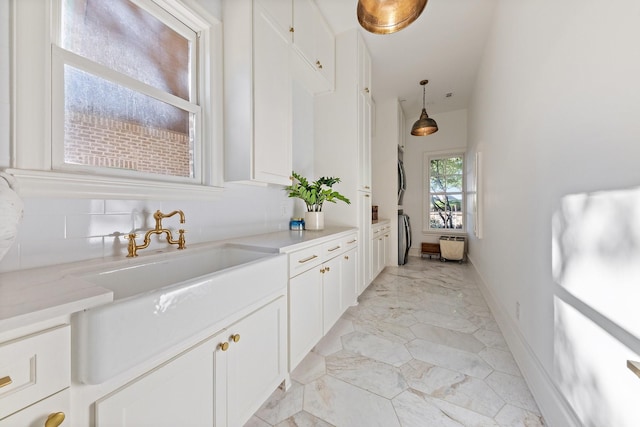 2 Terrabella Ln, Heath, TX 75032 - bar featuring light marble finish flooring, pendant lighting, and baseboards