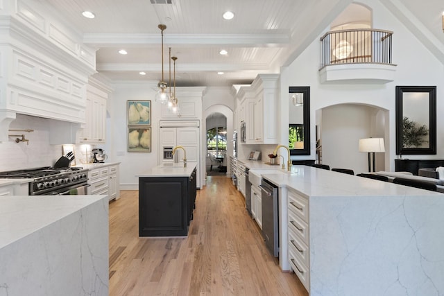 2 Terrabella Ln, Heath, TX 75032 - kitchen featuring arched walkways, light wood-style flooring, tasteful backsplash, white cabinetry, and beamed ceiling