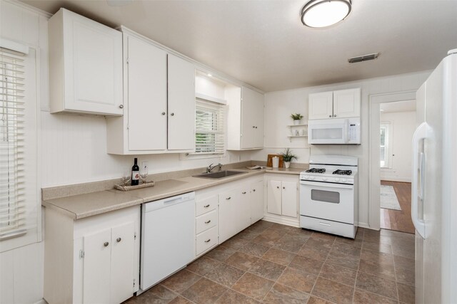 1311 Oak St, Mckinney, TX 75069 - kitchen with white appliances, a sink, white cabinetry, light countertops, and stone finish flooring