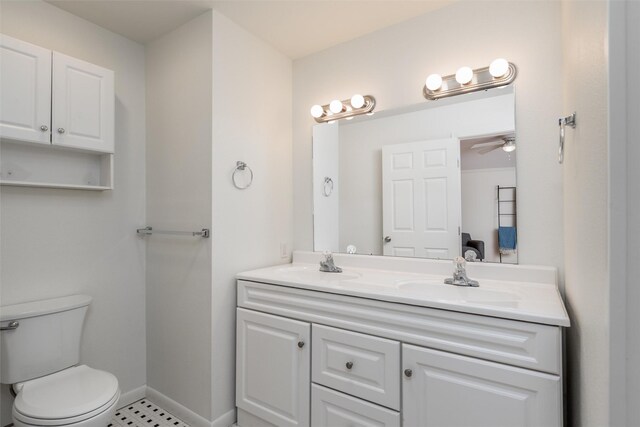 1311 Oak St, Mckinney, TX 75069 - full bath with double vanity, a ceiling fan, toilet, and baseboards