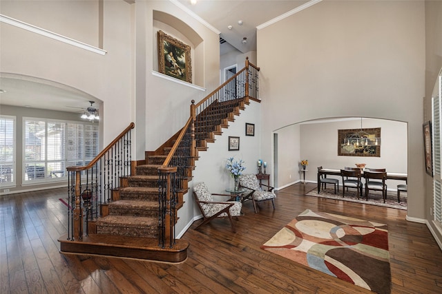 437 Fox Trl, Allen, TX 75002 - entryway with arched walkways, a towering ceiling, stairs, hardwood / wood-style floors, and crown molding