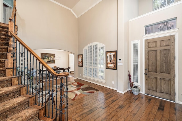 437 Fox Trl, Allen, TX 75002 - entryway featuring arched walkways, hardwood / wood-style flooring, crown molding, stairway, and baseboards