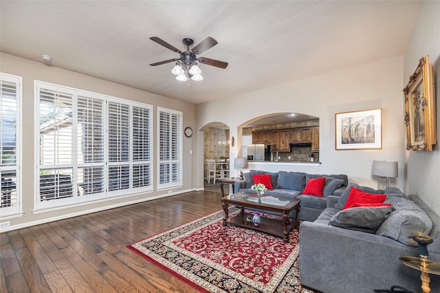 437 Fox Trl, Allen, TX 75002 - living area featuring arched walkways, a ceiling fan, wood finished floors, and baseboards