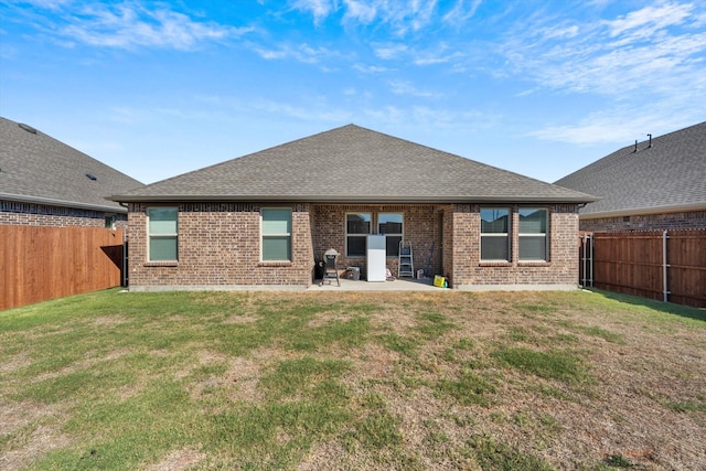719 Dove Haven Way, Lavon, TX 75166 - back of property featuring brick siding, a patio area, and roof with shingles