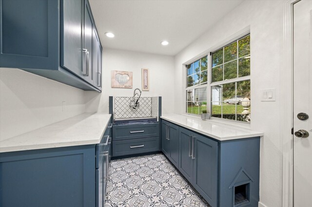 145 Vista Dr, Eustace, TX 75124 - kitchen featuring blue cabinetry, tasteful backsplash, recessed lighting, light tile patterned flooring, and light stone counters