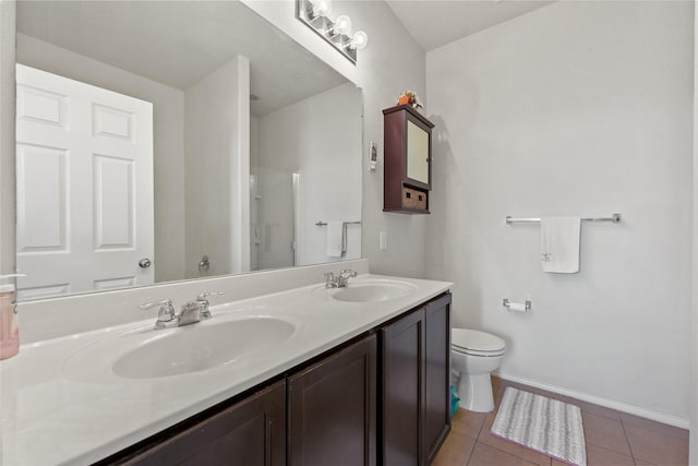 1816 Gayla Creek Dr, Little Elm, TX 75068 - bathroom featuring double vanity, toilet, tile patterned flooring, and baseboards