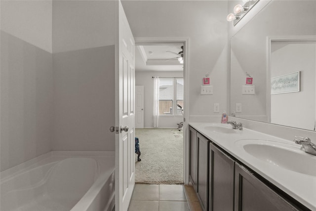 1816 Gayla Creek Dr, Little Elm, TX 75068 - full bathroom with a bath, a tray ceiling, double vanity, ceiling fan, and tile patterned flooring