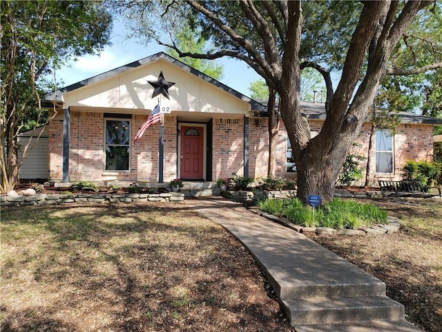 3102 Chestnut Rd, Carrollton, TX 75007 - view of front facade featuring brick siding and covered porch